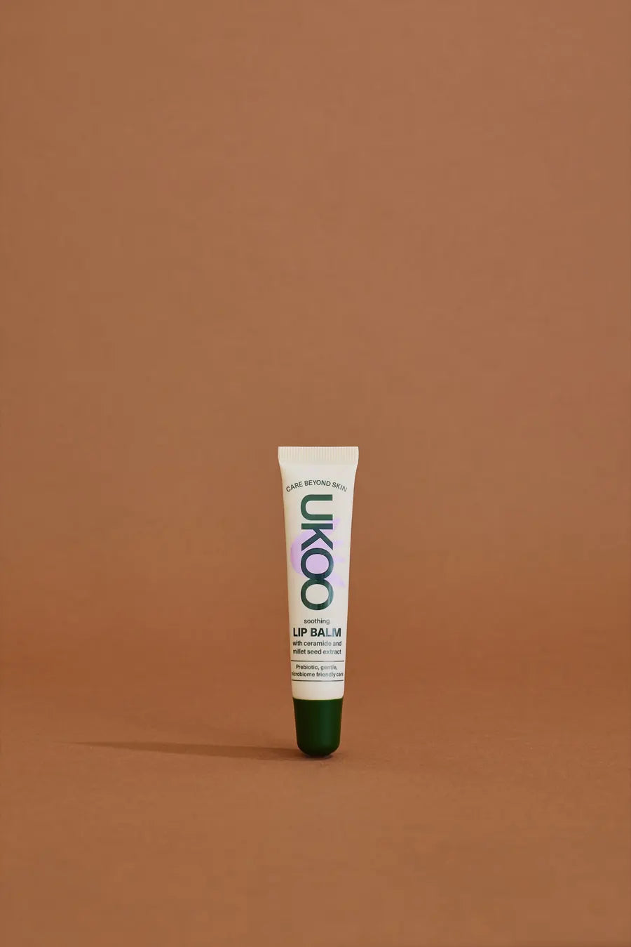 UKOO lip balm standing on terracotta