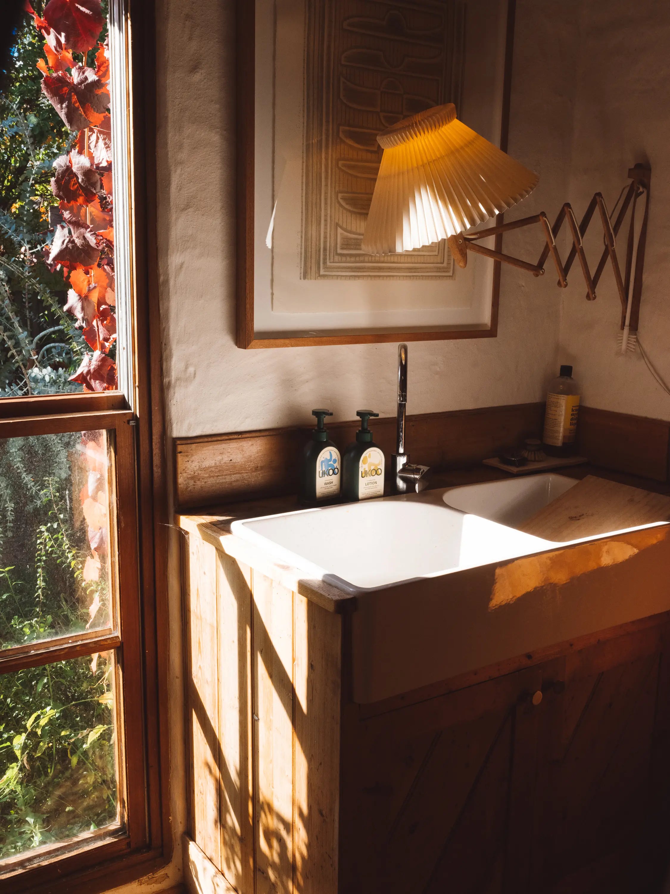 UKOO wash and lotion beside a farmhouse sink in late afternoon light